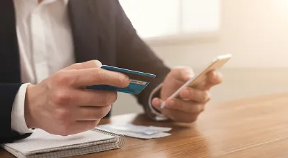 this image displays a professional immigraton consultant is sitting in his office and managing to open a bank account for this clinet according to his demands.