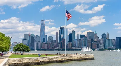 This visually striking image captures a vibrant American cityscape with a serene lake in the foreground, symbolizing growth, stability, and opportunity—perfectly framed beneath a waving American flag, evoking pride, legal legitimacy, and the promise of the American dream. In the background, towering high-rise buildings rise prominently, representing the economic hubs of major U.S. metropolitan areas such as New York, Miami, Austin, or Los Angeles, where global investors are actively establishing businesses and securing their future through the U.S. E-2 Treaty Investor Visa program. The scene is tailored to attract international entrepreneurs, startup founders, and high-net-worth investors from treaty countries seeking long-term U.S. residency, business expansion in America, and multi-generational benefits through a renewable E-2 visa. Expertly positioned for commercial intent, this image speaks to clients searching for E-2 visa eligibility guidance, investment amount requirements, U.S. business plan development, DS-160 processing, and consular approval strategies with maximum success rates. Whether investing in franchises, tech startups, or service-based enterprises, E-2 applicants gain work authorization, spousal employment eligibility, and fast-track entry without a direct path to a green card—making it one of the most flexible investor visa options in the USA. With supporting services like E-2 business structuring, regional economic impact planning, and visa renewal support, this image powerfully conveys opportunity, professionalism, and strategic immigration planning—positioning your consultancy as the premier choice for end-to-end E-2 investor visa services, helping global entrepreneurs legally live, operate, and thrive in the United States through smart, compliant, and scalable business immigration solutions.
